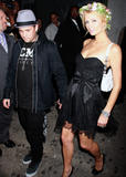Paris Hilton shows cleavage an legs in small black dress partying at Tao nightclub in New York